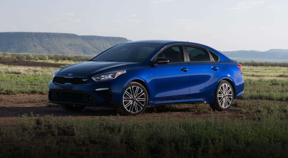 A blue 2020 Kia Forte parked on a sunny day.