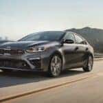 A gray 2020 Kia Forte GT driving on a highway.