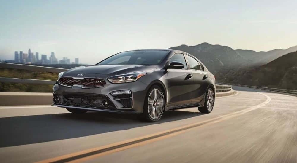 A gray 2020 Kia Forte GT driving on a highway.
