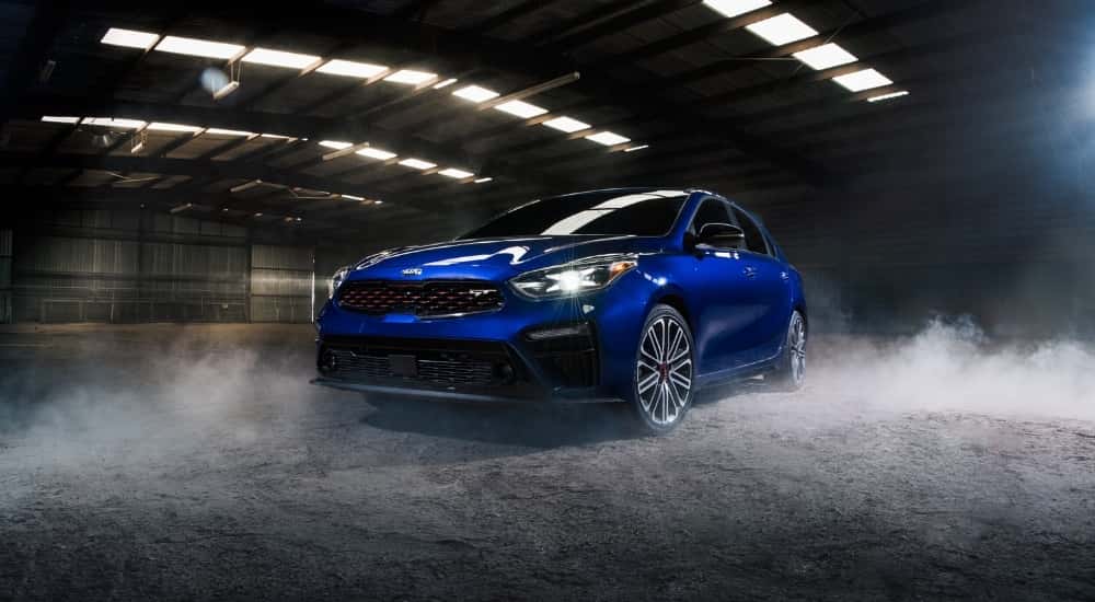 A blue 2020 Kia Forte GT parked in a hangar.