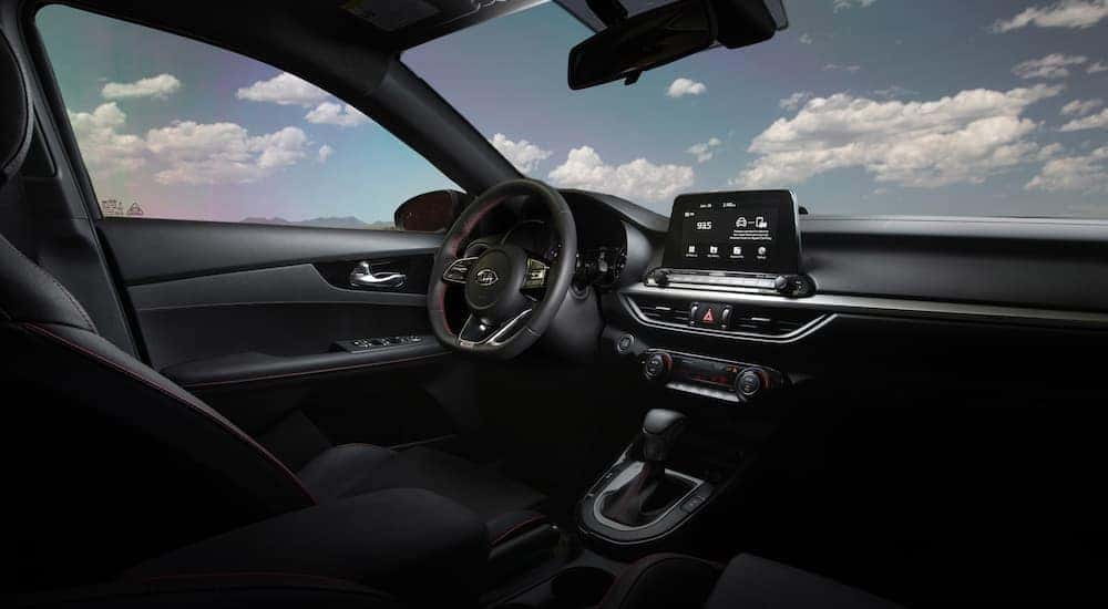 The black interior and dash in a used 2020 Kia Forte for sale.