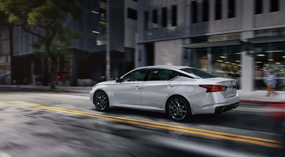 A silver used 2024 Nissan Altima driving in a city