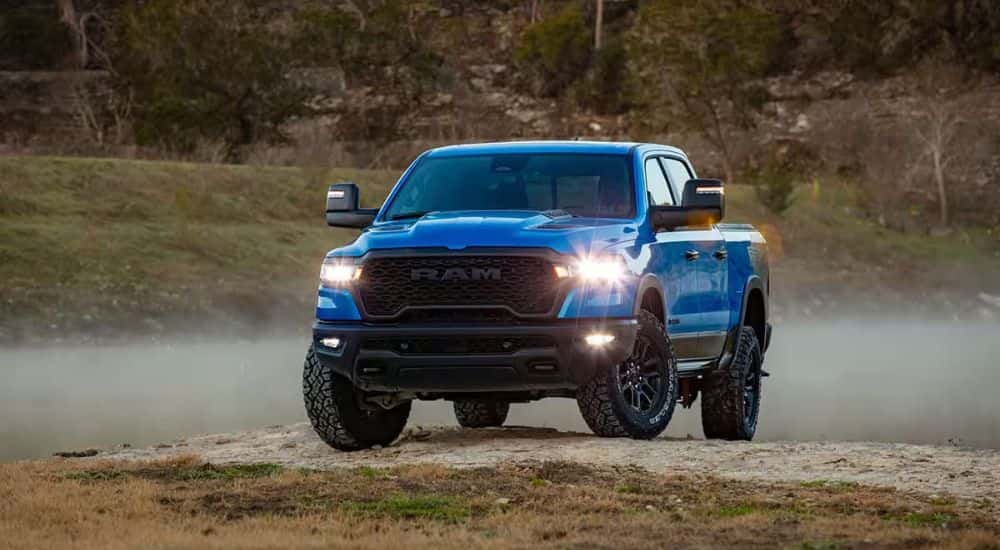 A blue used 202 Ram 1500 Rebel parked off-road for sale