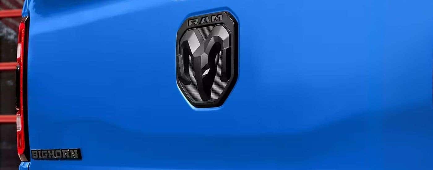 Black Ram emblem on a blue used 2023 Ram 1500 Big Horn Built to Serve Edition