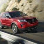 Red 2019 Ford Explorer driving up a mountain.