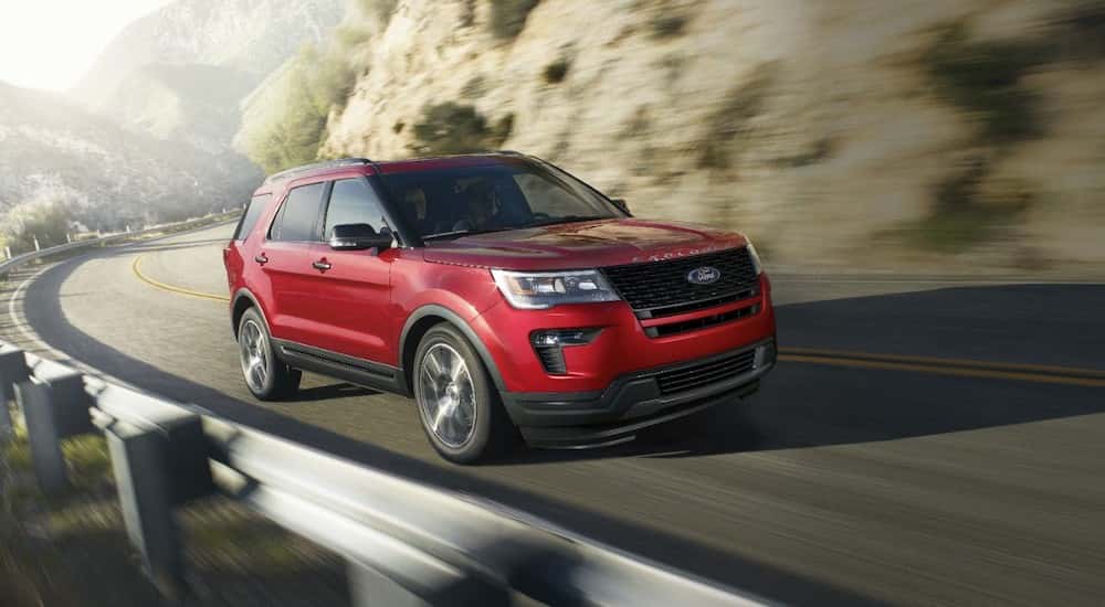 Red 2019 Ford Explorer driving up a mountain. 