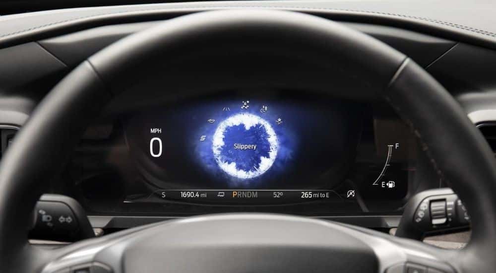 Digital gauge cluster showing the slippery drive mode, a safety feature in a 2021 Ford explorer for sale. 