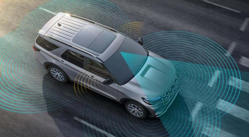 Silver 2025 Ford Explorer showing the various sensors and safety features it comes equipped with. 