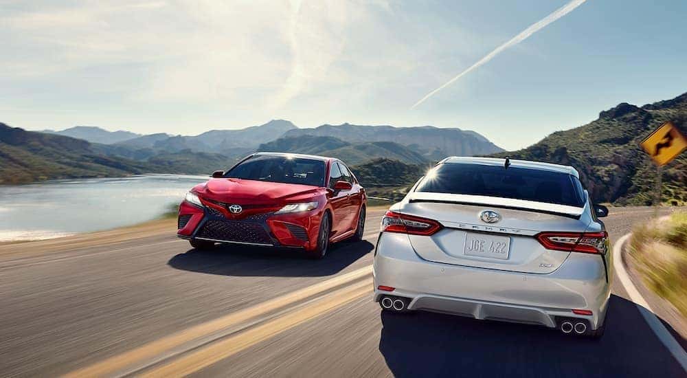Two 2018 Toyota Camry XSE pass each other on the road.