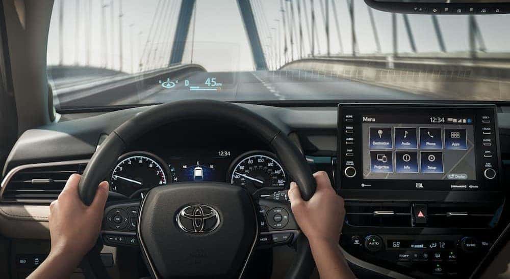 A person driving in a 2024 Toyota Camry.