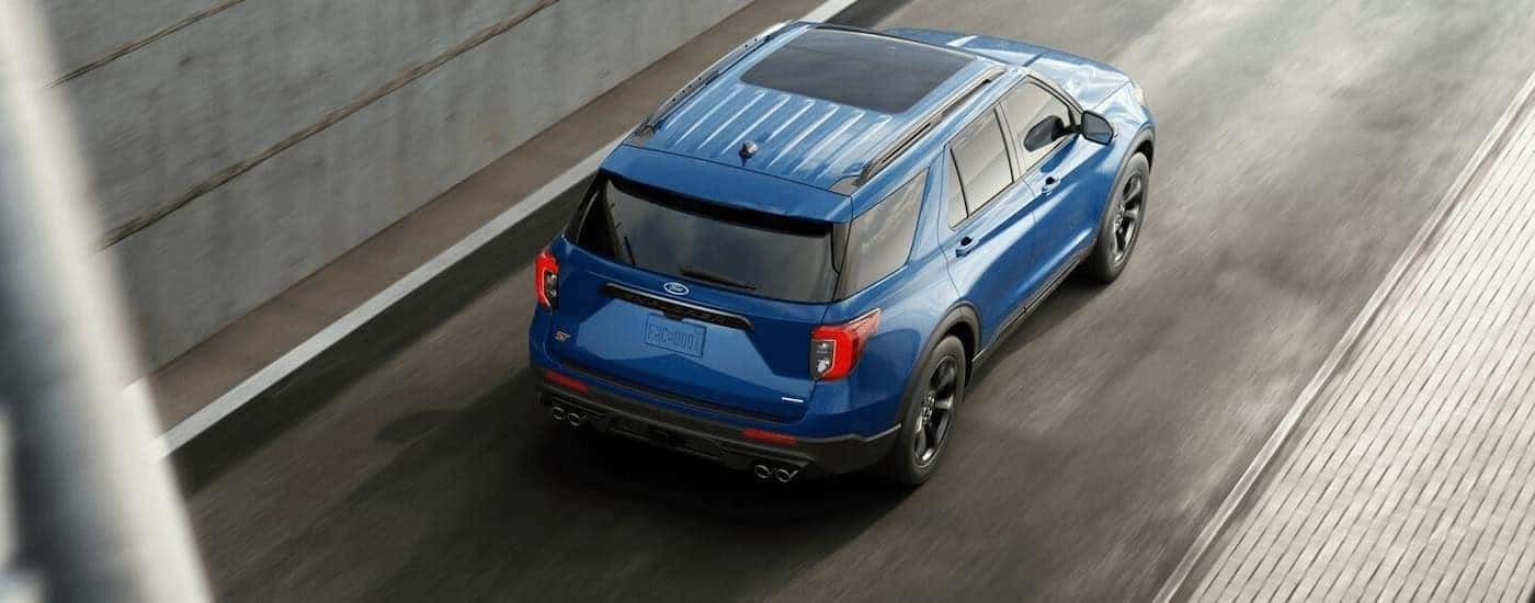 A blue 2025 Ford Explorer from the rear at an angle.