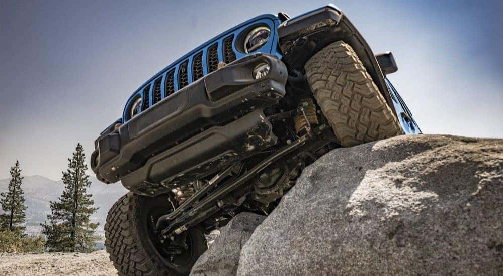 Blue 2022 Jeep Wrangler parked on a rock
