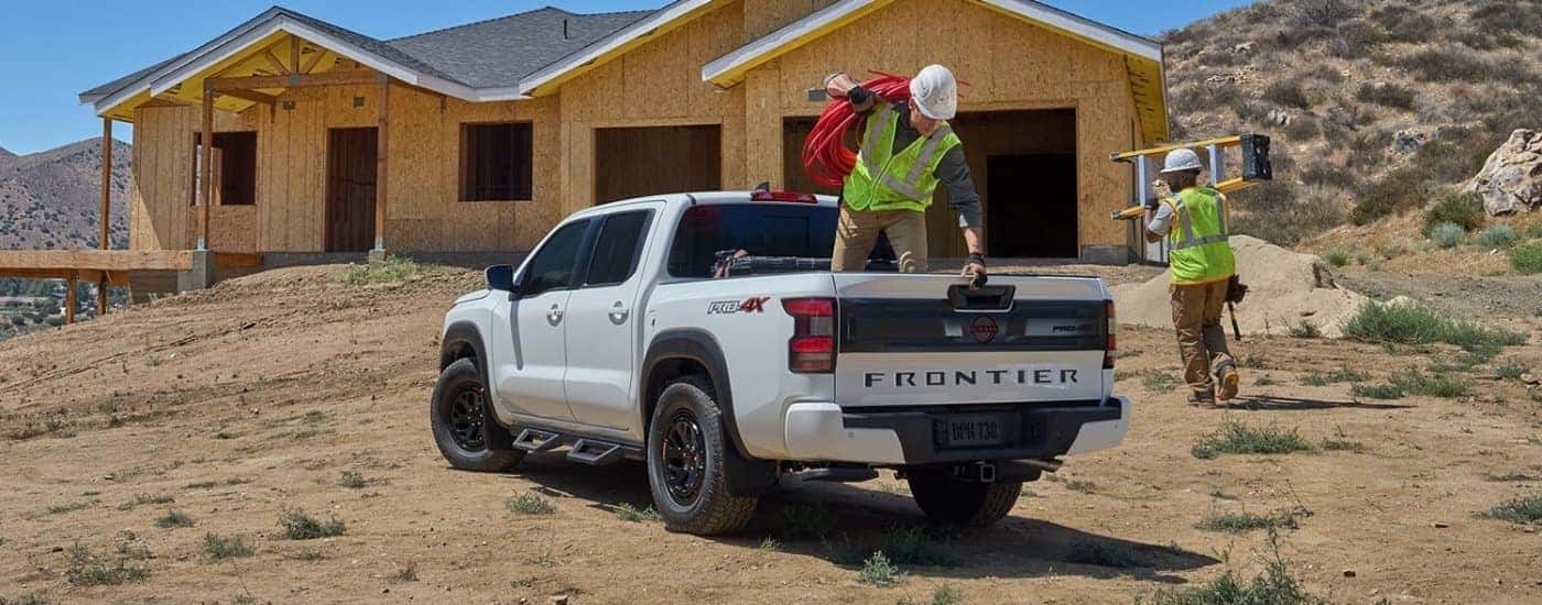 A white 2025 Nissan Frontier from the rear at an angle.