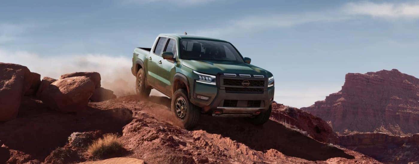 A green 2025 Nissan Frontier front at an angle.