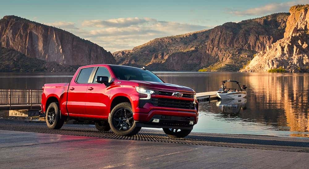 A red 2022 Chevy Silverado 1500 Z71 parked near a dock.