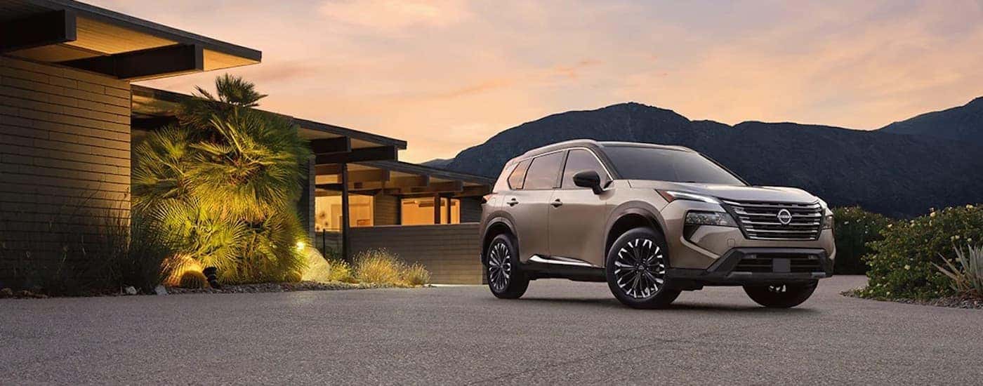 A bronze 2024 Nissan Rogue from the front.