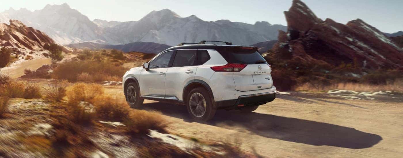 A white 2022 Nissan Rogue from the rear at an angle.