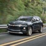 A black 2022 Chevy Blazer driving from a dealer with used SUVs for sale in Knoxville