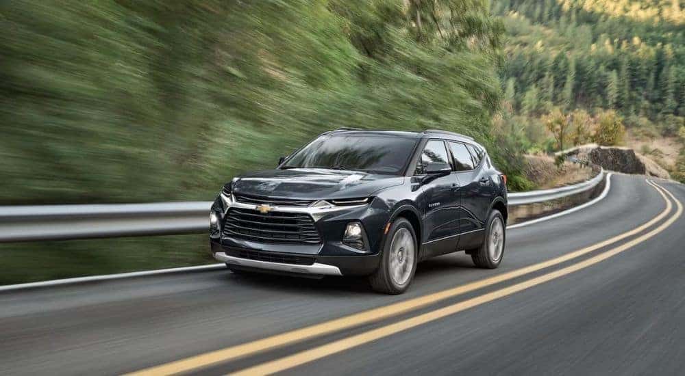 A black 2022 Chevy Blazer driving from a dealer with used SUVs for sale in Knoxville