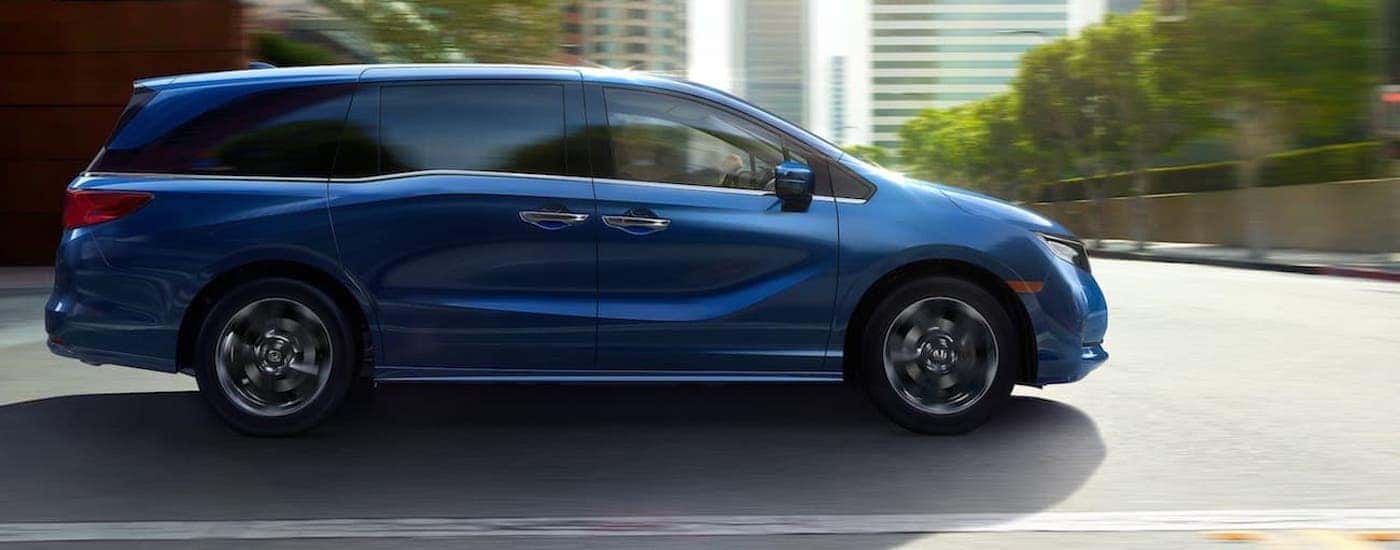 A blue 2022 Honda Odyssey from the side.
