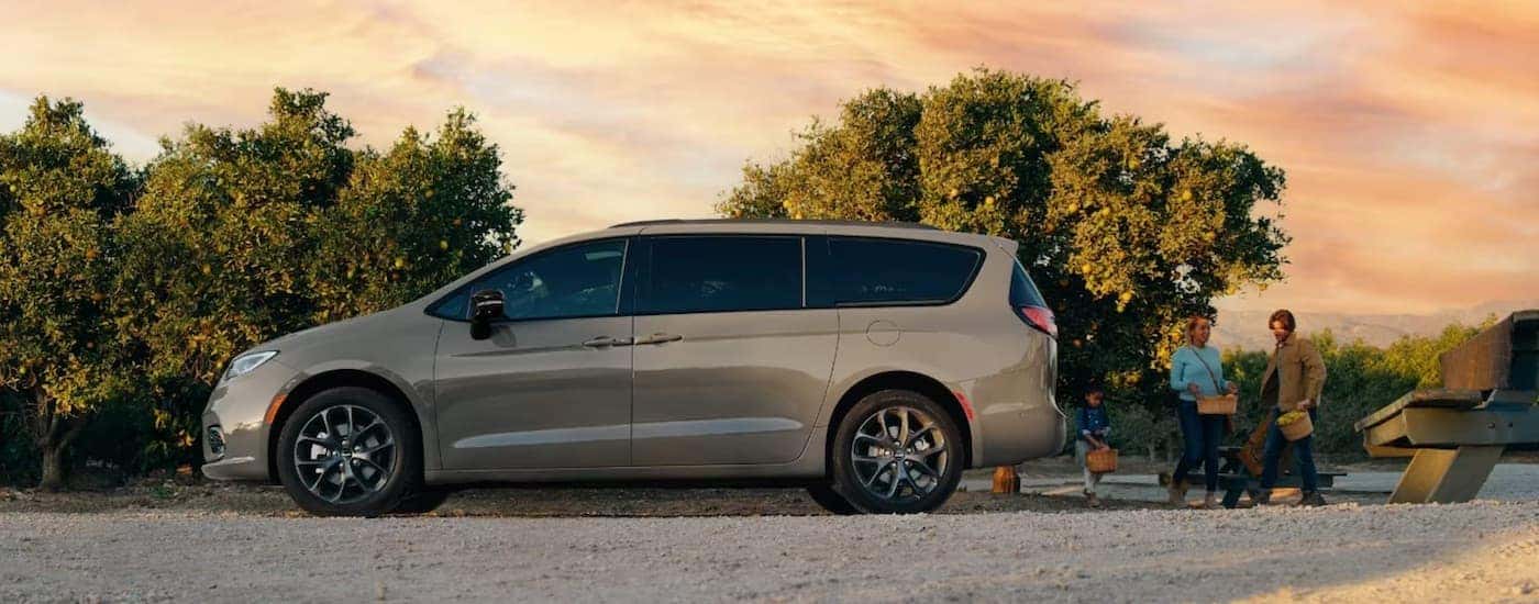 A tan 2023 Chrysler Pacifica from the side.