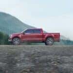A red 2023 Ford F-150 parked off-road.