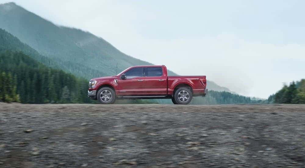 A red 2023 Ford F-150 parked off-road.