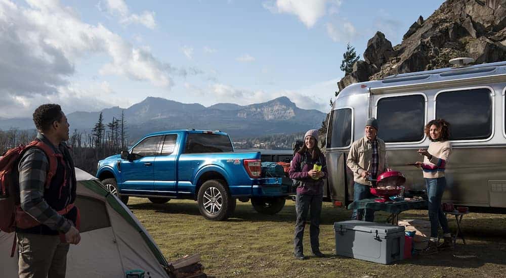 Blue 2022 Ford F-150 at a campsite
