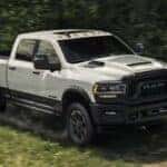 A white 2023 Ram 2500 Rebel off-roading for sale in Columbus