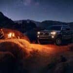 Black 2023 Toyota Tacoma parked at a campsite at night