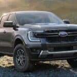 Grey 2024 Ford Ranger parked on rocks near a lake