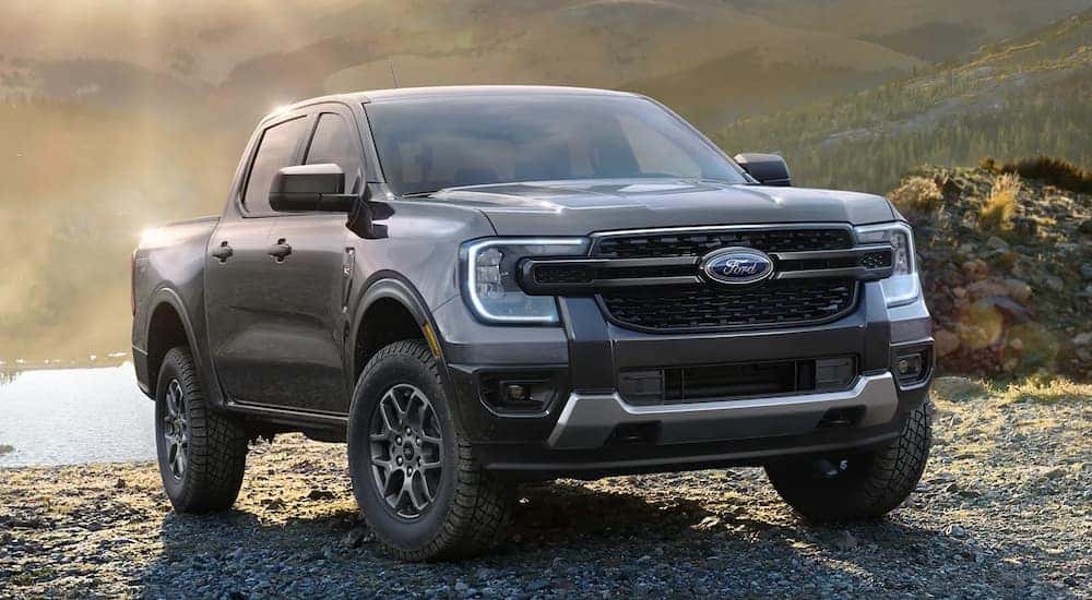 Grey 2024 Ford Ranger parked on rocks near a lake