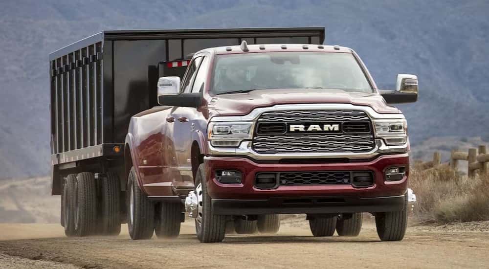 A red 2024 Ram 3500 towing a trailer