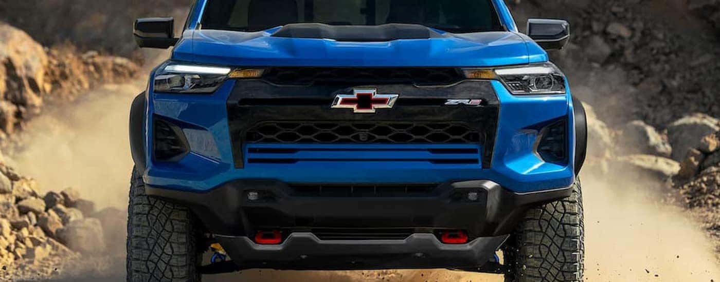 A blue 2025 Chevy Colorado ZR2 off-roading on a trail