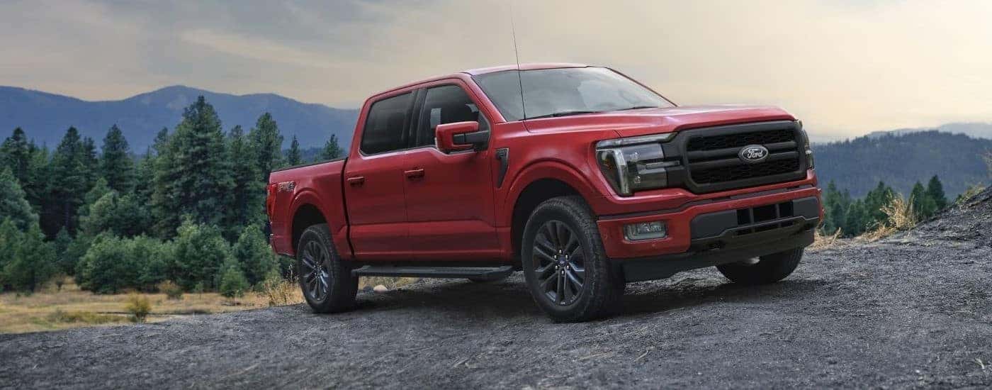 A red 2025 Ford F-150 Lariat parked off-road