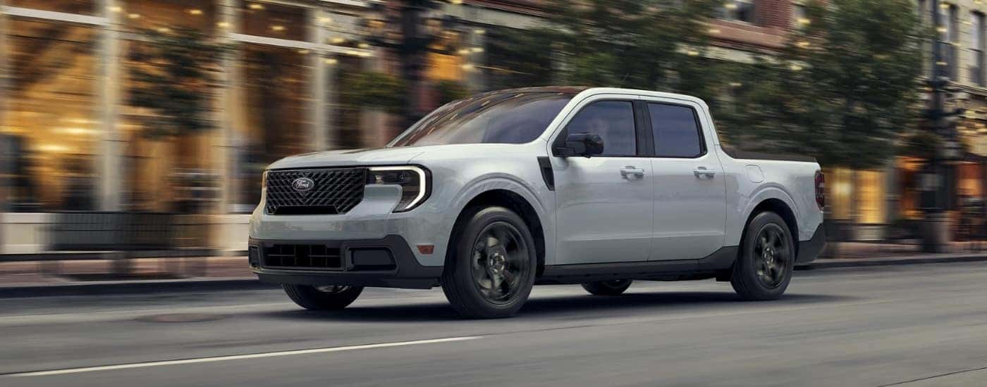 A silver 2025 Ford Maverick driving in a city