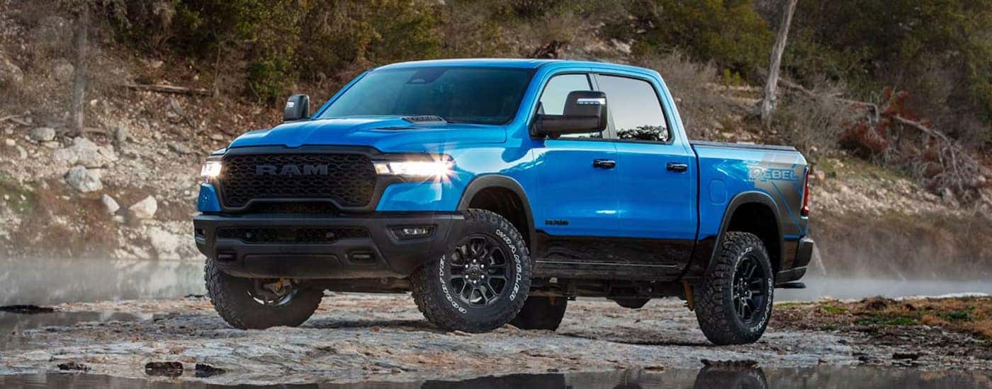 A blue 2025 Ram 1500 Rebel parked off-road