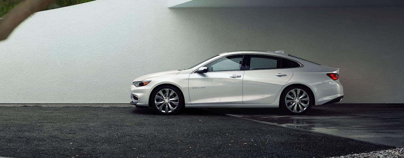 White 2016 Chevy Malibu parked against a wall