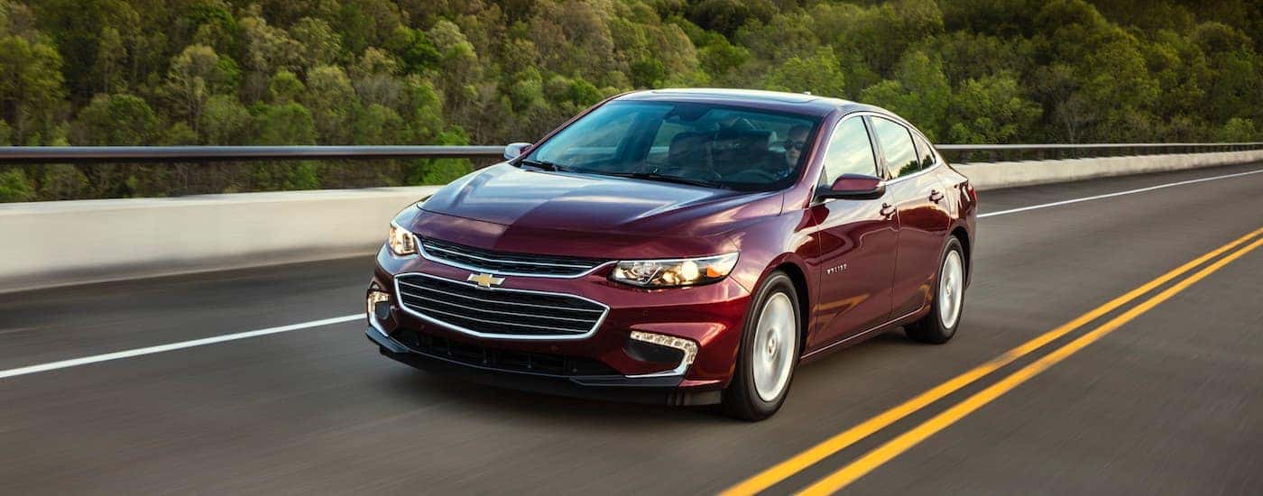 Maroon 2018 Chevy Malibu driving to view used cars for sale near Knoxville
