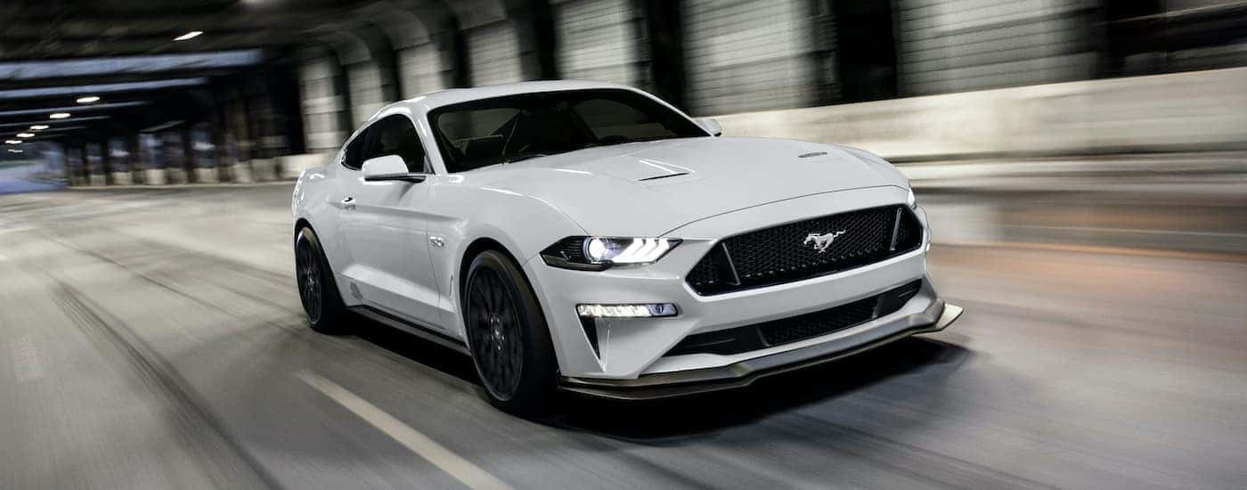 White 2020 Ford Mustang GT driving through a tunnel