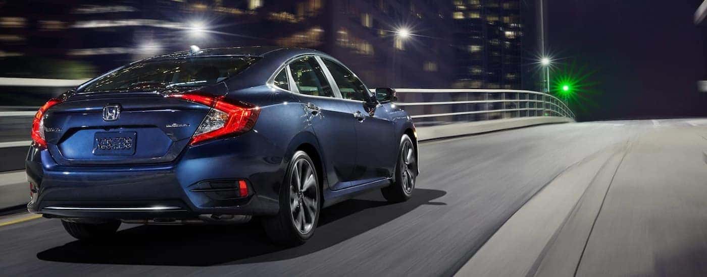 Blue 2020 Honda Civic driving through a city