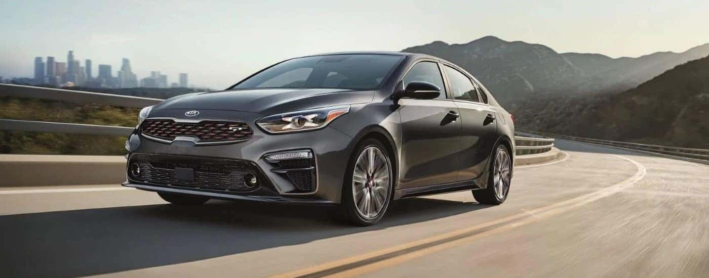 Grey 2020 Kia Forte GT driving to a used car dealer near Knoxville