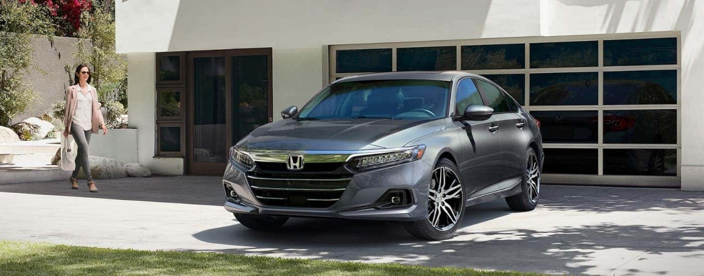 Silver 2021 Honda Accord Touring parked in front of a garage