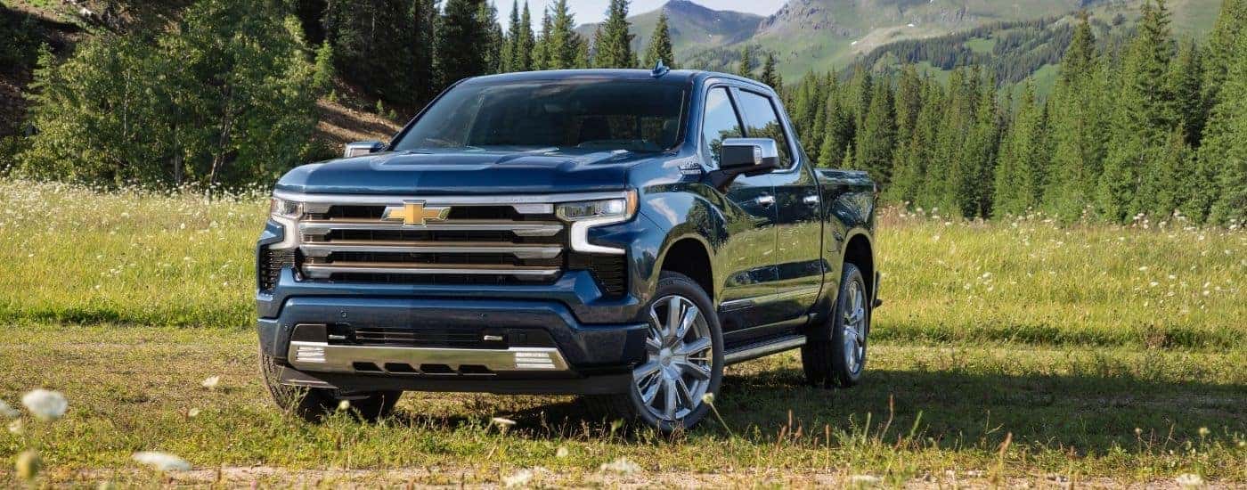 Blue 2022 Chevy Silverado 1500 High Country parked on a field