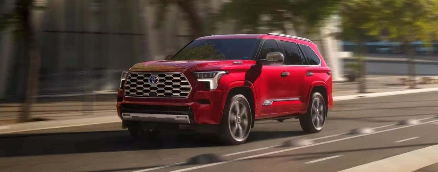 A red 2024 Toyota Sequoia is shown from the front at an angle.