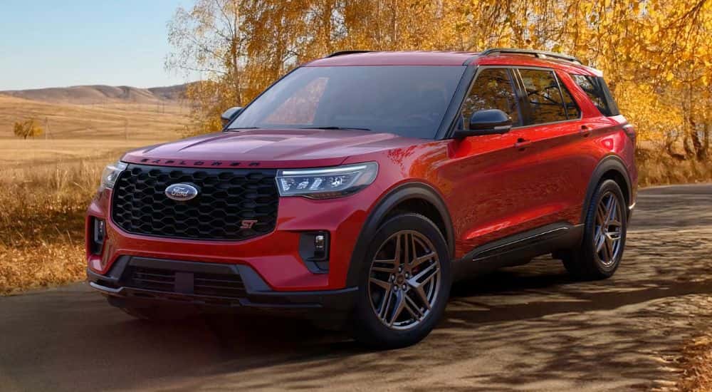 Red 2026 Ford Explorer on a road in the fall
