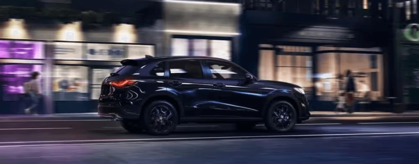 A black 2023 Honda HR-V Sport is shown driving.