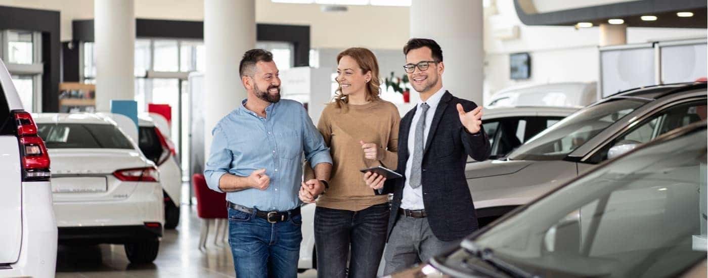 Salesman talking to customer about their car trade-in