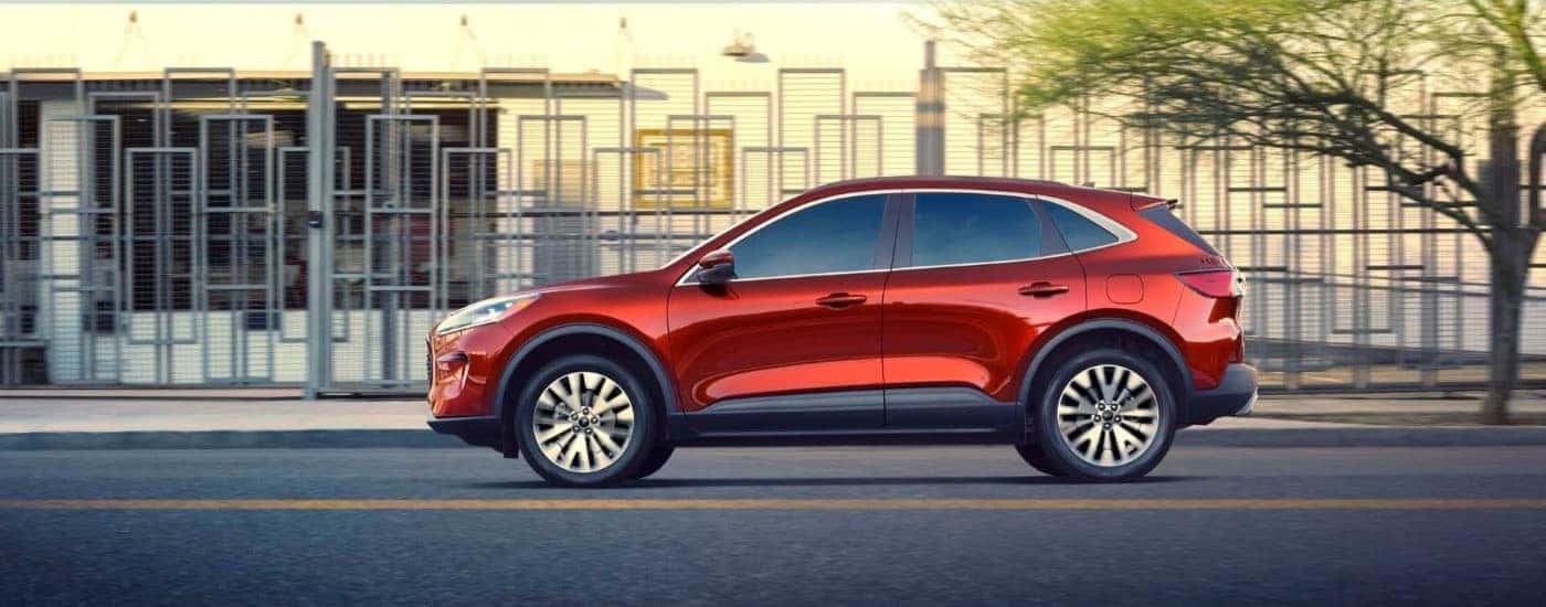 Red 2020 Ford Escape driving down a city street