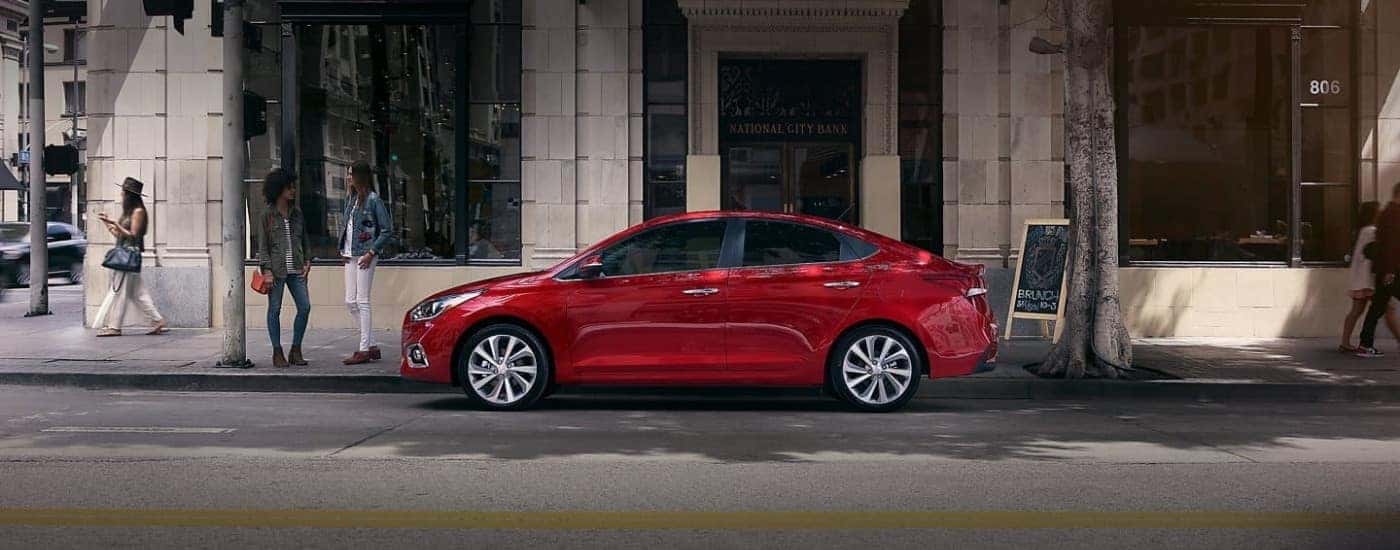 A red 2020 Certified Pre-Owned Hyundai Accent is shown parked on a city street.